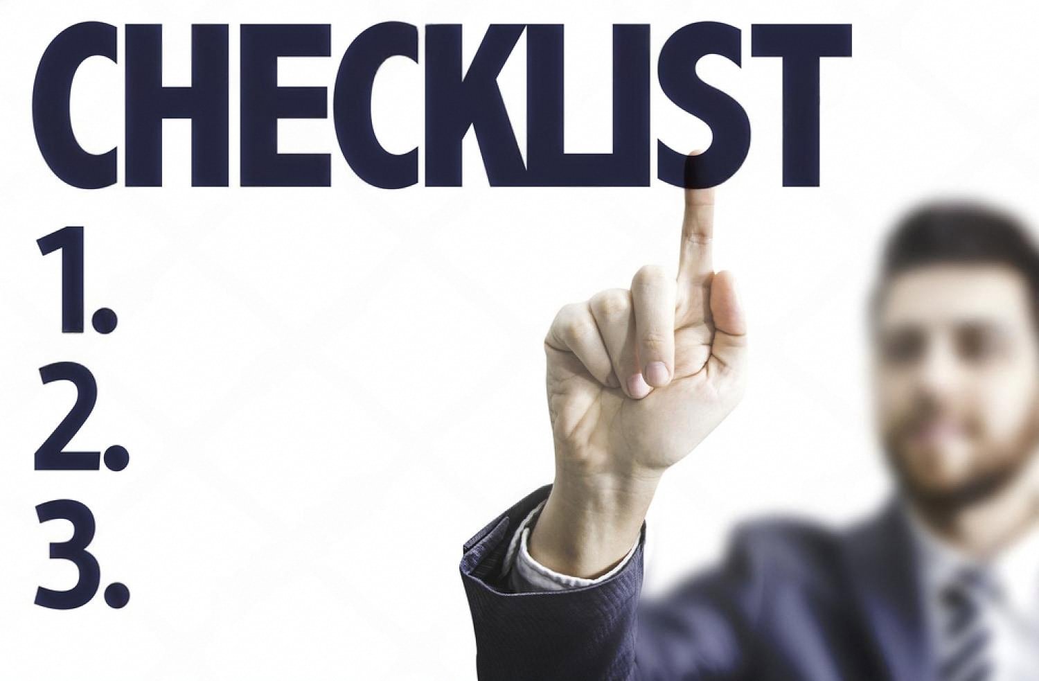 Businessman pointing at a compliance audit checklist with numbered items